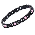 Schwarzes Magnettherapie-Armband mit rosa Kristallen und X-Gliedern auf weißem Hintergrund. - X-Form Rosa Strass / Länge 20 cm x Breite 0,8 cm / Schwarz