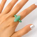 Hand wearing a natural green aventurine hexagonal crystal pillar beaded elastic ring - Green Aventurine