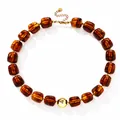Amber acrylic irregular beaded necklace with central gold metallic accent bead. - Amber Yellow