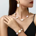 Elegant gold-tone jewelry set with white shell-style rectangular pendants. - Square Earrings + Necklace + Bracelet Set