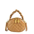 Detail shot of tan quilted handbag with scrunchie handle and gold zippers for women. - Khaki