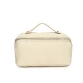Close-up front view of a minimalist cream checkered texture portable cosmetic storage bag - Off White