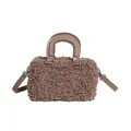 Detail view showing the curly plush faux fur texture and smooth handles of this brown bag. - Coffee