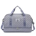 Close-up of the quilted texture and separate bottom compartment on this travel bag. - Foggy Blue