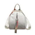 Front view of stylish white shell-shaped mini backpack with colorful woven straps - Off White