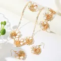 Detailed view of vintage white enamel flower necklace, bracelet, and earring set in gold tone. - Necklace+Bracelet+Ring+Earrings
