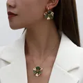 Elegant close-up showing the green enamel flower necklace and earrings set on a model - Flower Necklace Earring Set / Green