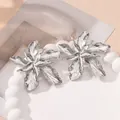 Close-up of oversized 3D metallic flower earrings with intricate wrinkled texture - Style 11 Silver
