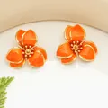 Elegant orange enamel flower stud earrings with gold-tone trim for forest summer - Earrings / Orange