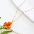 Vibrant orange enamel flower pendant necklace featuring a minimalist gold-tone link chain. - Necklace / Orange