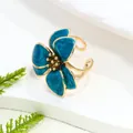 Adjustable teal blue enamel flower ring with gold-tone finish for a forest vacation style - Ring / Blue