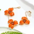 Elegant orange enamel flower bracelet with gold-tone chain for women's vacation style - Bracelet / Orange