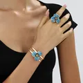 Elegant blue enamel flower bracelet and ring set worn by model for a luxury look - Ring Bracelet Set / Blue