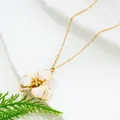 Minimalist gold chain necklace featuring a delicate white enamel flower pendant - Necklace / White
