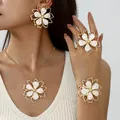 Elegant gold-plated jewelry set featuring white enamel flower earrings necklace ring and cuff - Jewelry Set / White