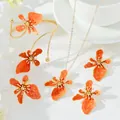 Elegant orange enamel flower jewelry set including necklace, bangle, and earrings. - Set / Orange