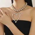 Close-up of a silver beaded necklace with an irregular hollow heart pendant on a model - Metal Ball Chain Style / Silver