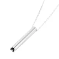 Close-up detail of the polished silver titanium steel meditation whistle pendant. - Silver