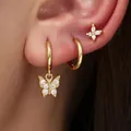 Macro detail of stylish gold butterfly hoop earring set with sparkling CZ stones on ear. - Butterfly 3-Piece Set (82TED) / Gold