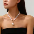 Elegant baroque pearl necklace with gold toggle clasp and irregular pendant on model. - Irregular Pearl Pendant Necklace / Gold