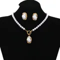 Elegant baroque irregular pearl necklace and earrings set displayed on a black bust - Necklace and Earrings Set / Gold