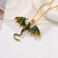 Close-up of retro dragon necklace with green enamel wings and shiny gold chain detail - Dragon Necklace / Green