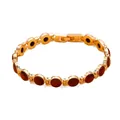 Elegante bracciale placcato oro con pietre occhio di gatto rosse tonde da donna. - Viola
