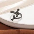 Detailed view of an adjustable gunmetal black musical note ring gift for music lovers - Open Adjustable / Black
