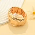 Chunky gold-toned bangle with an irregular pleated design for a bold fashion statement. - KC Gold