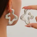 Detail view of large silver fluid wavy earrings with retro striped texture for women - Style 6 Silver