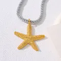 Close-up of golden starfish pendant with detailed metallic texture and silver braided cord - Chain Only / Gold