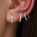 Set of three stylish silver-plated hoop earrings with crystal accents shown worn on ear - Twisted Rope Rhinestone 3-Piece Set (82TED) / Silver