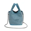 Detailed view of a blue rhinestone bucket bag featuring silver studs and a chain strap. - Blue