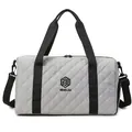 Front view of a quilted gray travel duffel bag with black handles and NINGJIA logo detail - Gray