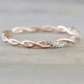 Detailed macro view of a rose gold twisted ring featuring elegant inlaid crystals - Size 6 / Rose Gold