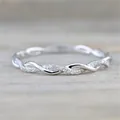 Macro detail view of a silver twisted wedding ring with shimmering pave stones - Size 6 / Silver