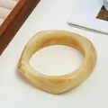 Unique irregular yellow marbled resin bangle bracelet with a polished wide surface - Ivory Inked Style (21 White Amber 42) / White Amber