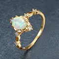 Detailed view of gold fashion ring with oval opal stone and sparkling zircon accents - Size 6 / Gold White Zirconia