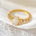 Vintage style gold-plated ring featuring an oval faux opal and moon accents - Size 6 / Gold White Zirconia