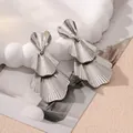 Close-up of vintage silver tiered leaf earrings with vertical striped textures - Style 12 Silver