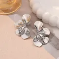 Close-up detail of silver-toned double-layered petal earrings with textured rippled surface. - Style 13 Silver