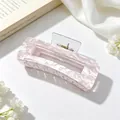 Detailed view of a large pink marble textured acrylic hair claw clip for elegant styling - Light Pink Marble