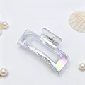 Close-up of elegant iridescent rectangular hair claw clip with decorative pearls - Phantom Transparent