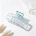 Macro detail of the iridescent gradient finish on a large square-shaped hair claw clip. - UV Electroplated Gradient Blue