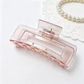 Macro close-up of translucent pink square hair claw clip with UV iridescent finish - Square Shark Clip / UV Plated Orange