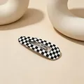 Close-up showing the detail of a black and white checkerboard hollow BB hair clip - Checkerboard (Waterdrop UV Snap Clip) / Black/White