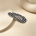 Detailed macro view of black and white houndstooth teardrop hollow hair clip - Houndstooth (Waterdrop UV Snap Clip) / Black/White