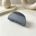 Close-up of a matte grey semi-circular hair claw clip on a minimalist background - Matte Dark Gray