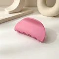 Close-up of a small matte pink semicircular hair claw clip on a minimalist background - Matte Dark Pink