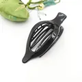 Detail view of a black glossy flat hair clip with sturdy internal teeth structure. - Glossy Black